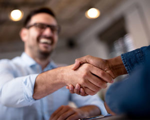 two men shacking hands happy about campaigner acquiring icontact