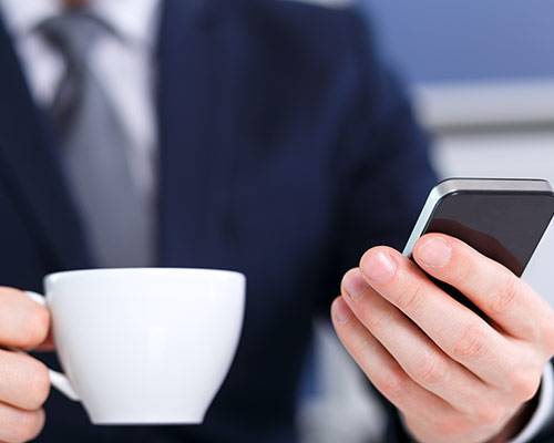 a business man reading on his phone the key to your email marketing success