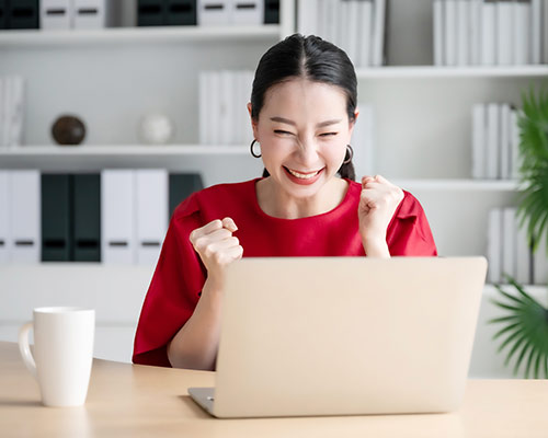 woman celebrating over guide evolve your email marketing strategy
