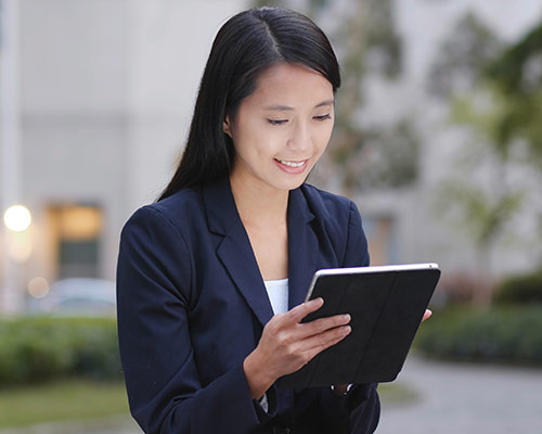 Young woman reviewing on a tablet email deliverability stats and spam rates